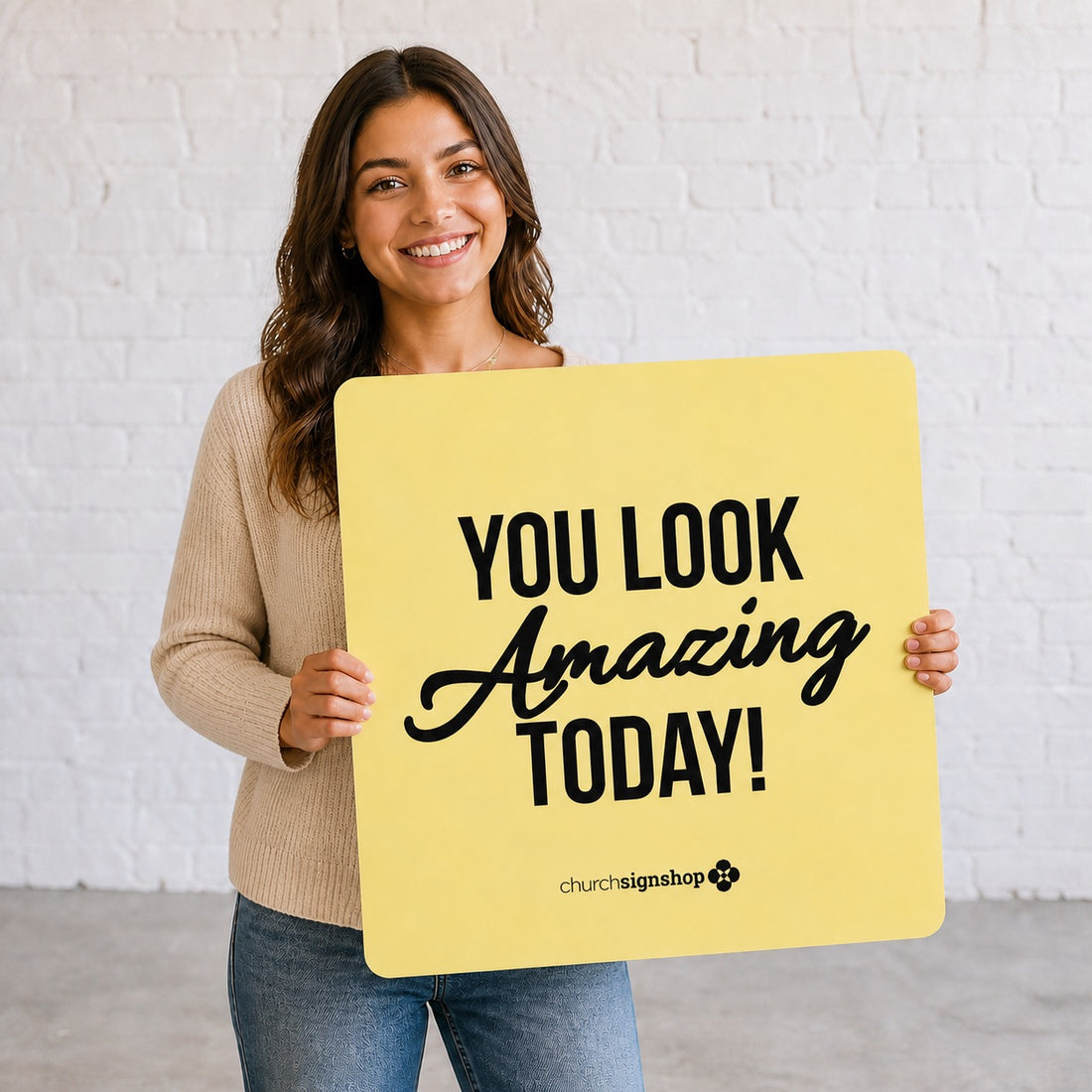 Greeter holding a yellow 22-inch square church welcome sign that reads You Look Amazing Today